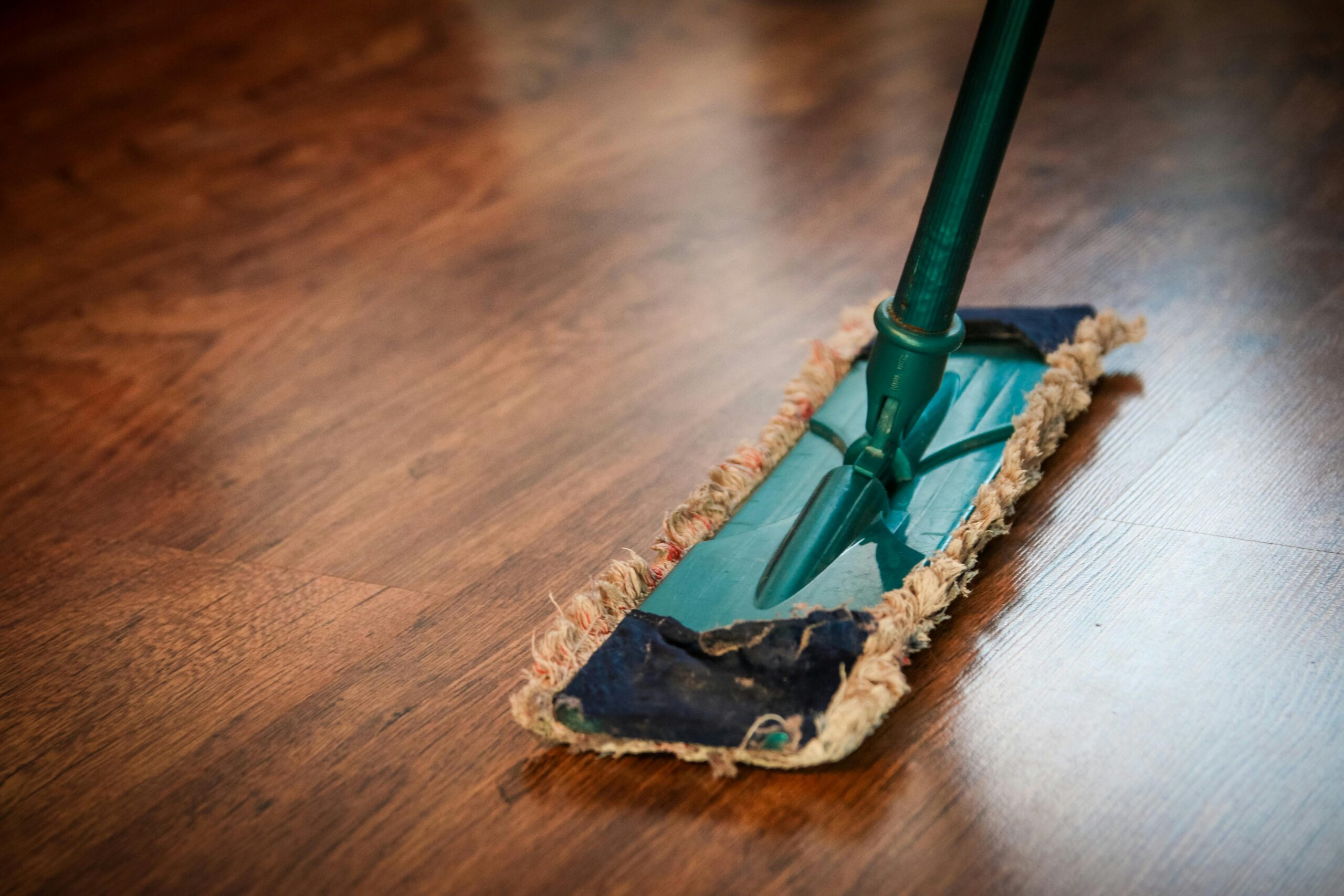 Green mop on hard floor.